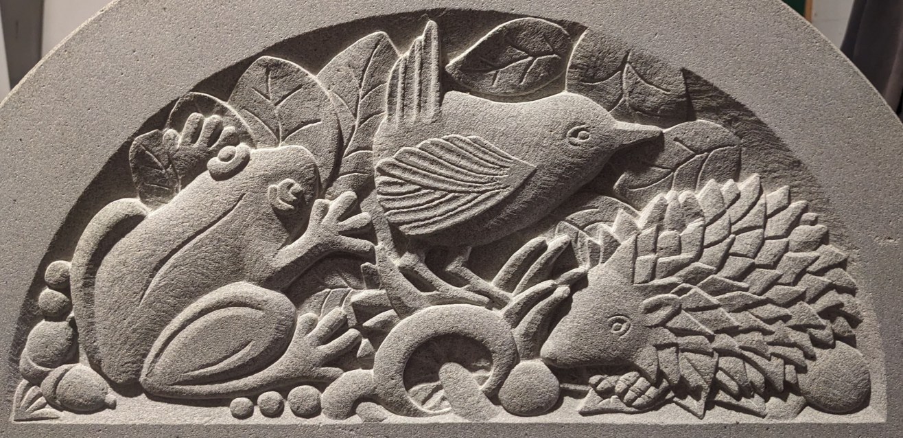 Forest of Dean sandstone carving of frog, wren and hedgehog